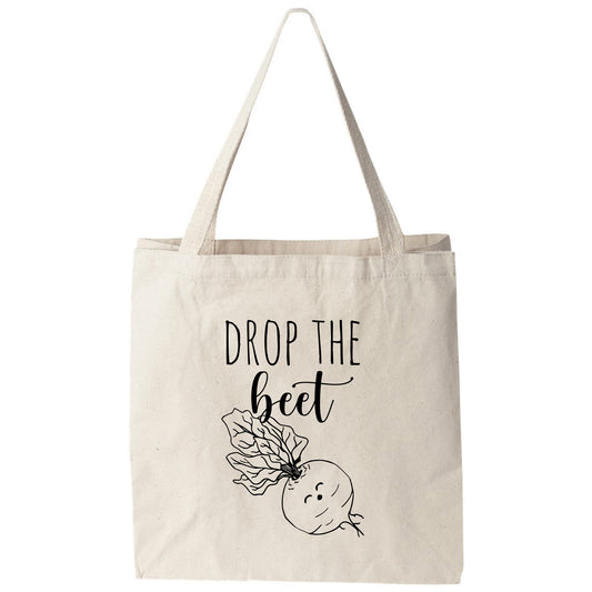 a tote bag that says drop the bed