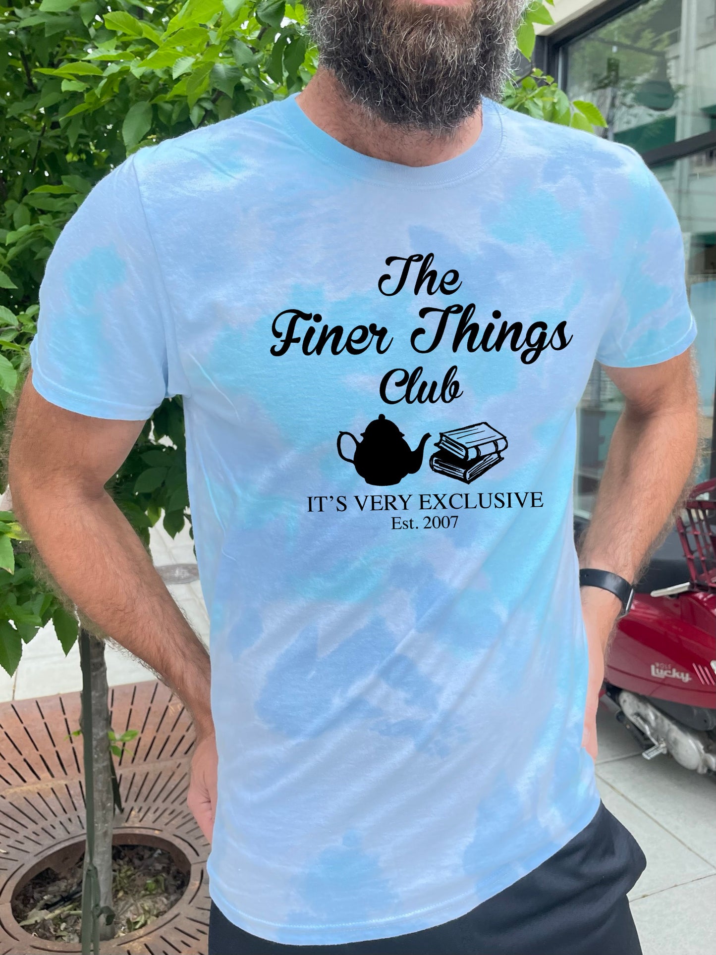 a man with a beard wearing a t - shirt that says the finer things club