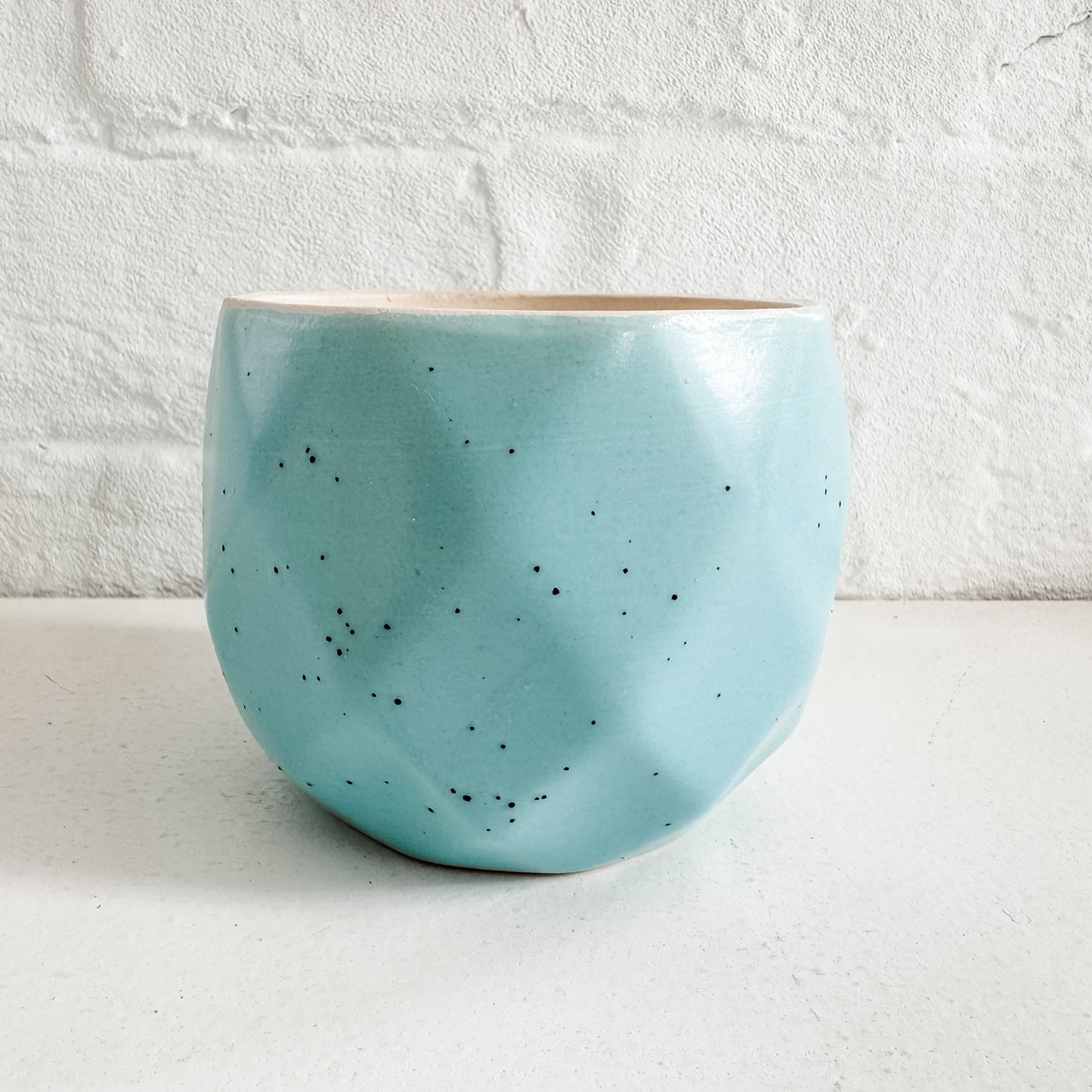 a blue bowl sitting on top of a white counter