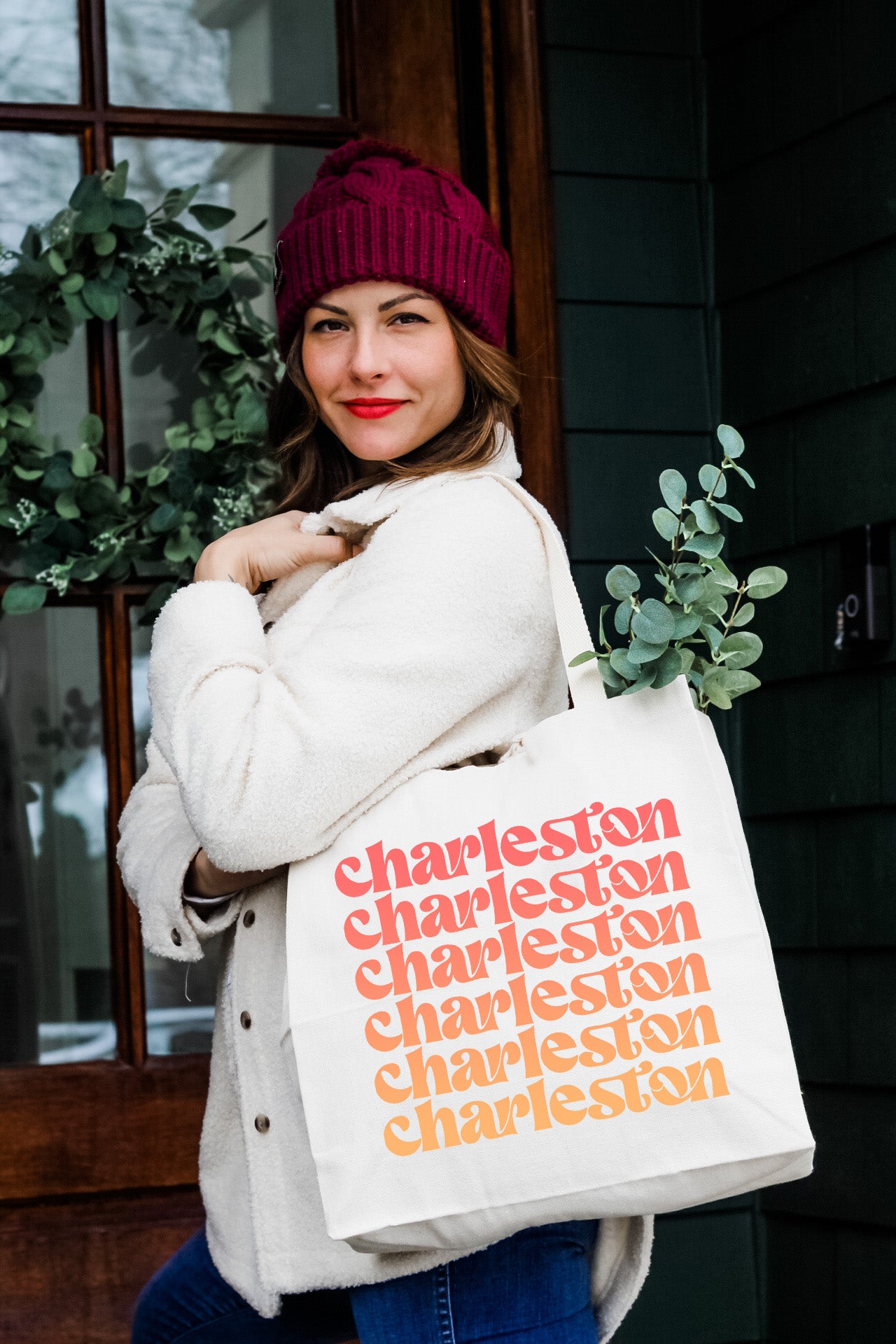 a woman is holding a bag that says charleston