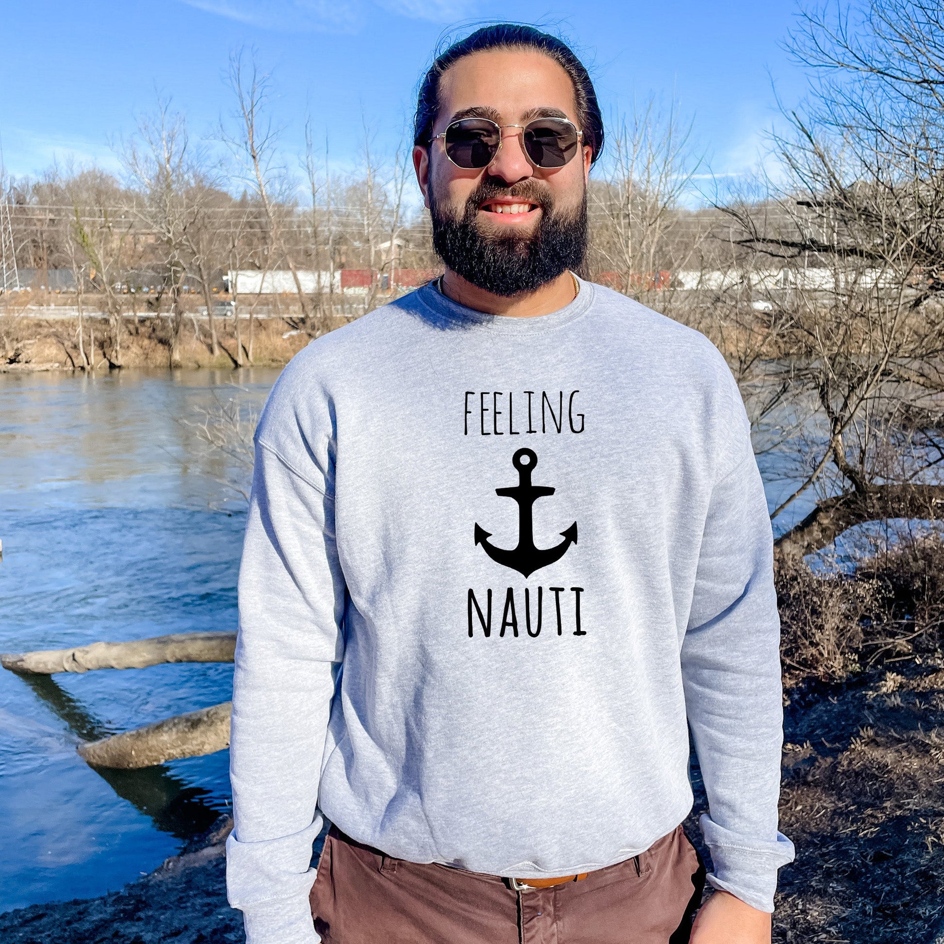 a man standing in front of a body of water