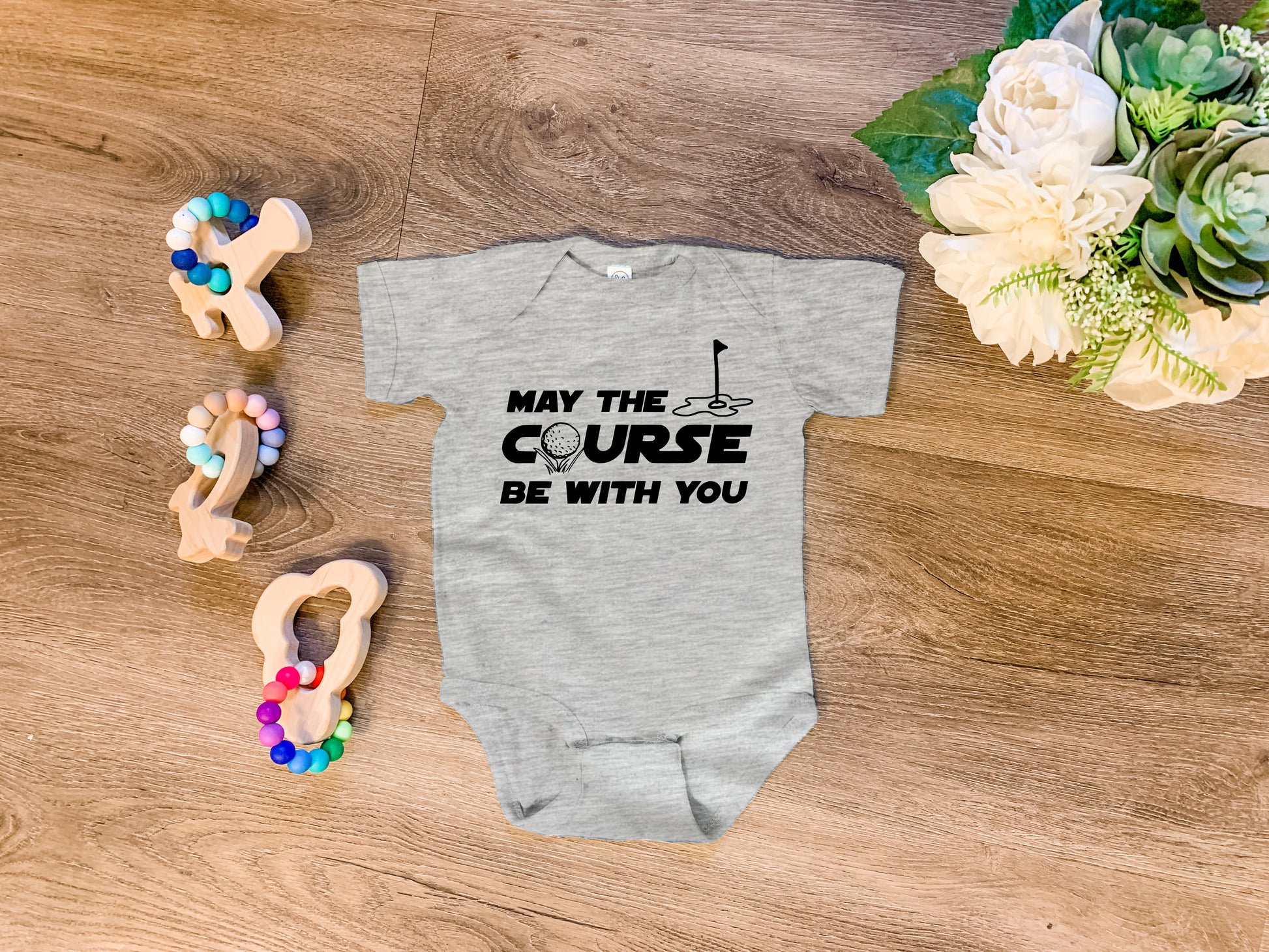 a baby bodysuit that says may the course be with you