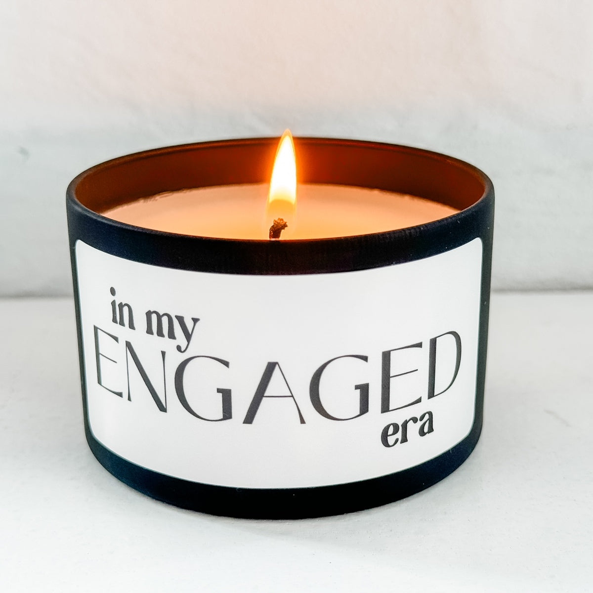 a candle with the words in my engaged era on it
