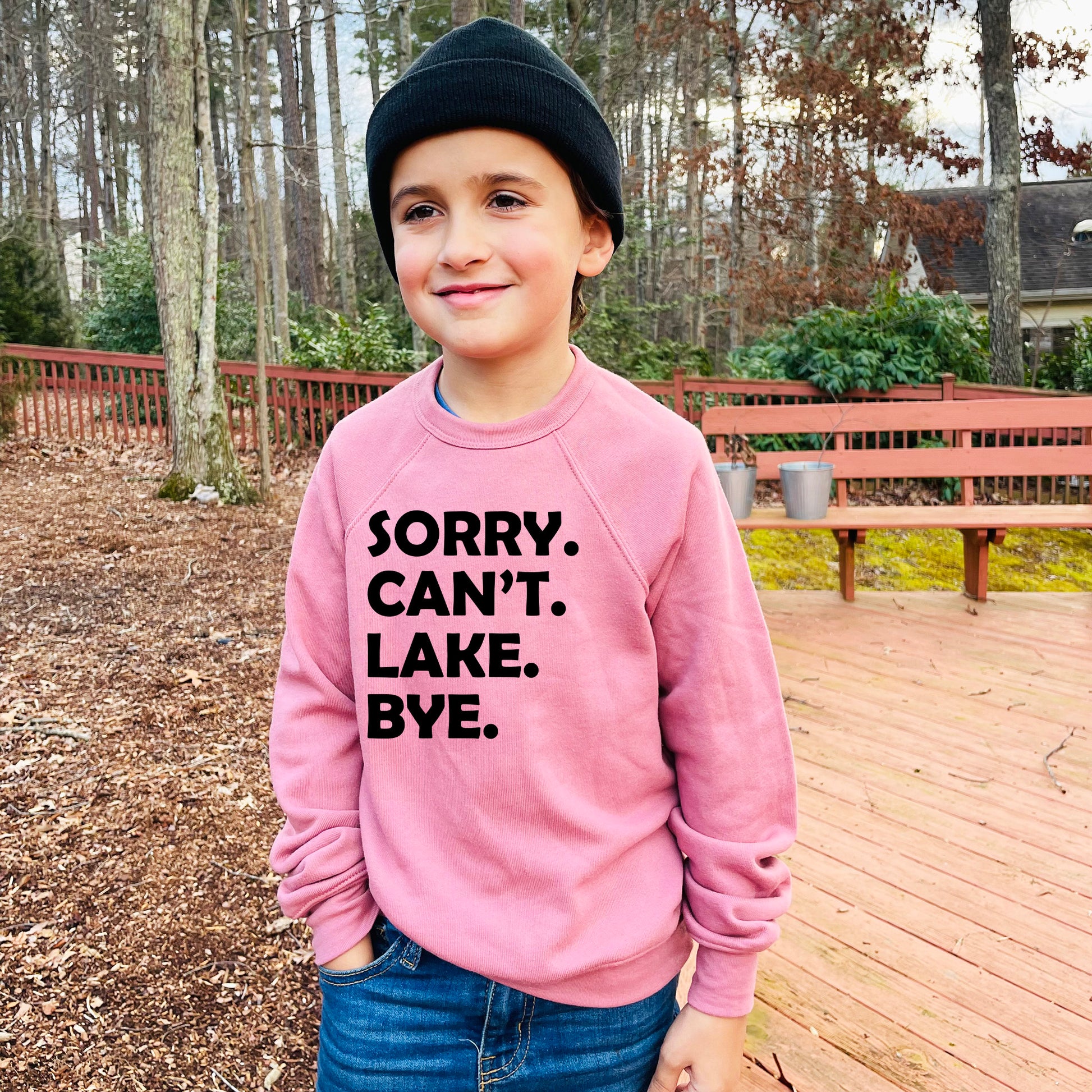 a young boy wearing a pink sweatshirt that says sorry, can't lake bye