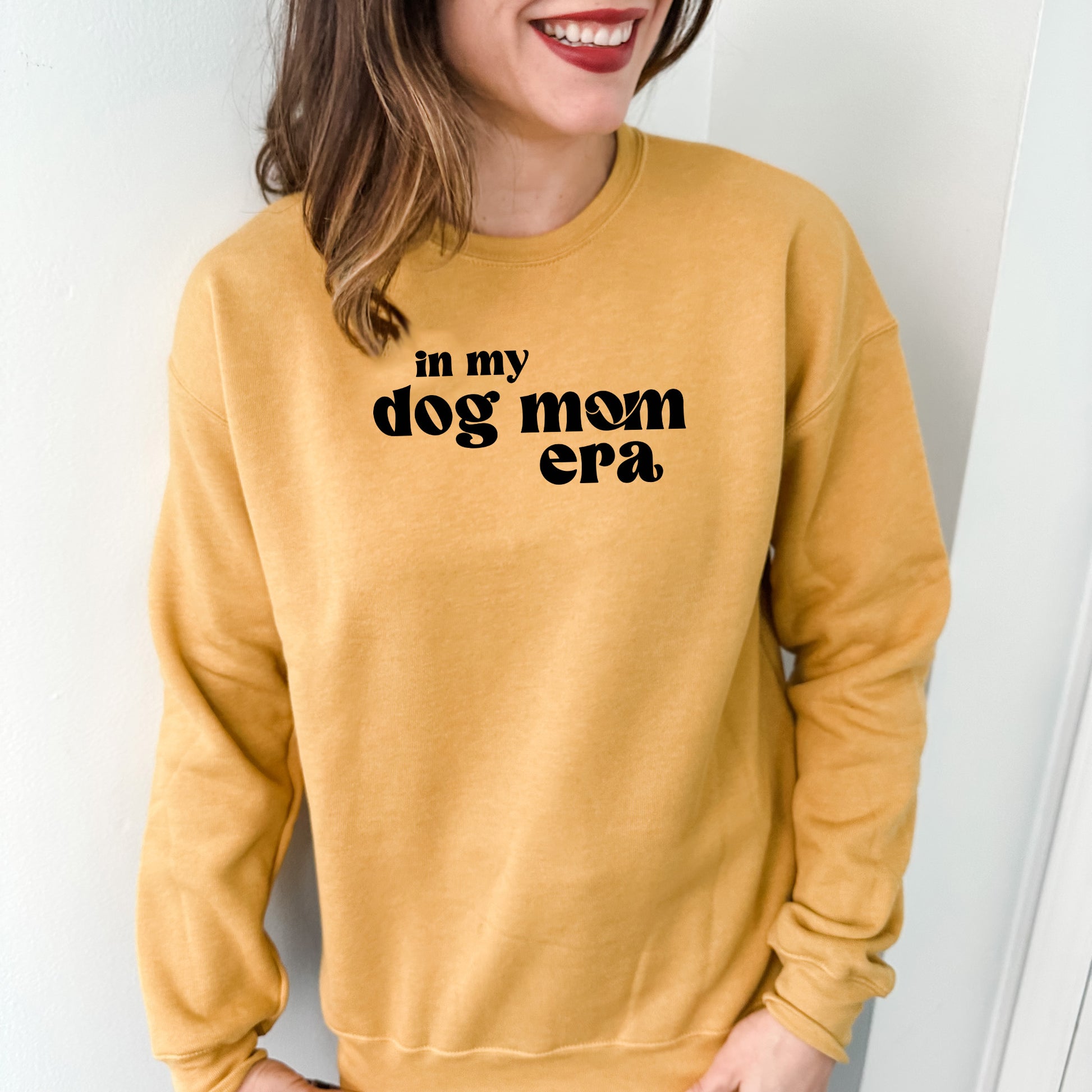 a woman wearing a sweatshirt that says in my dog mom era