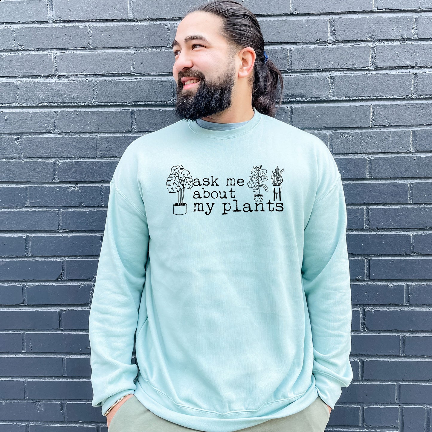 a man with a beard wearing a sweatshirt that says ask me about my plants