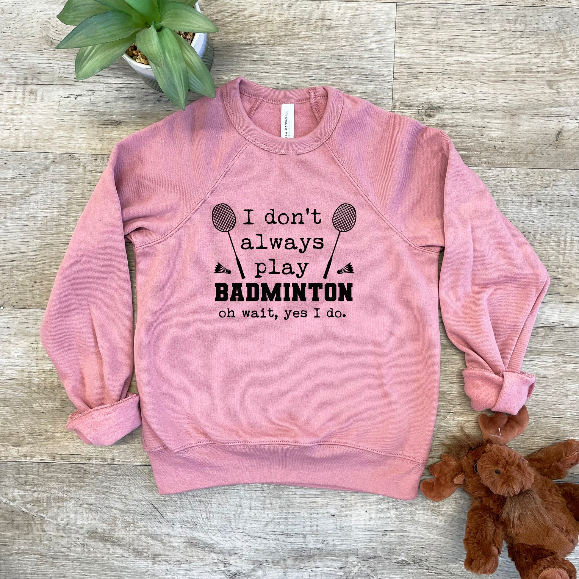 a pink sweatshirt that says i don't always play badminton on it