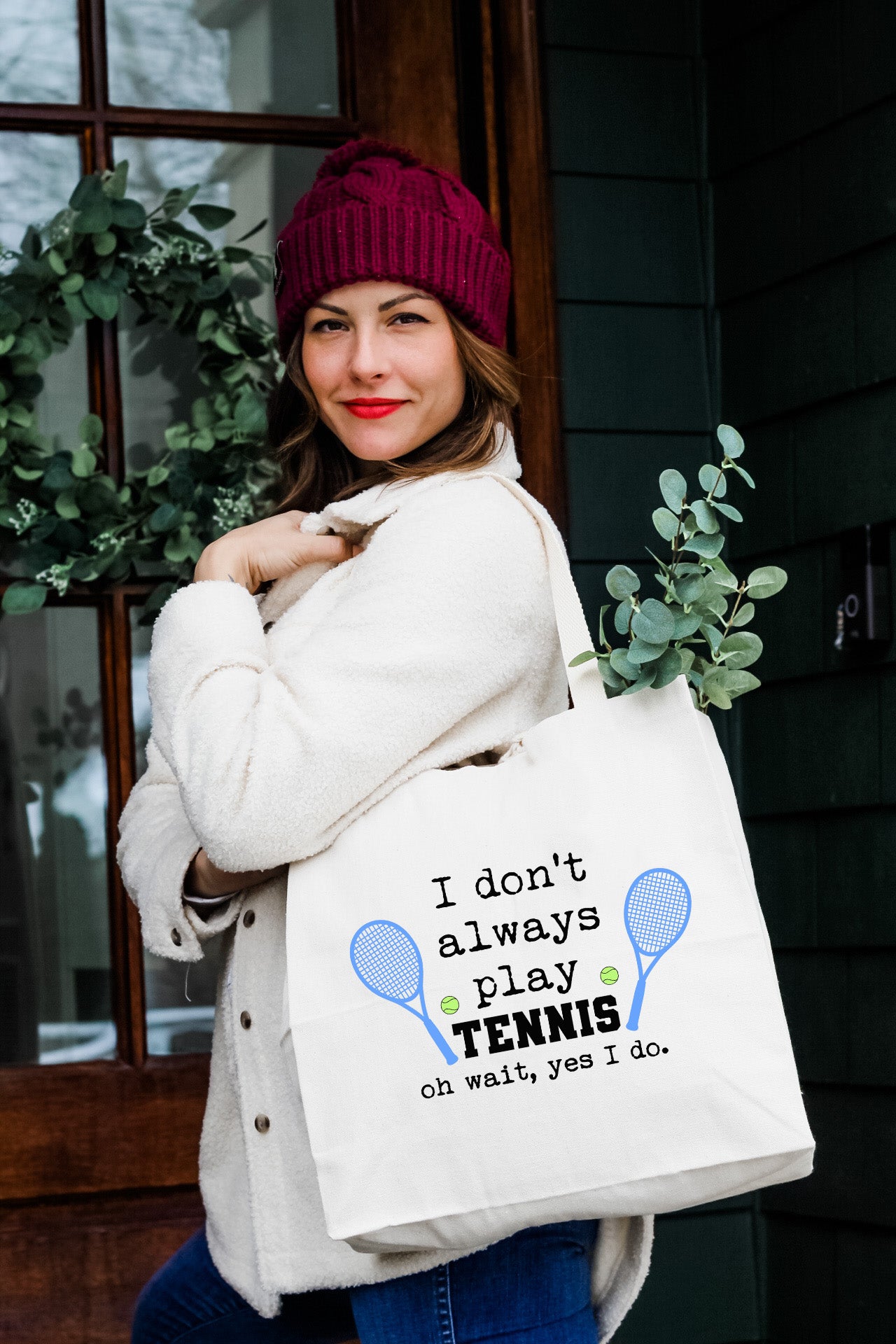 a woman holding a tennis racquet tote bag