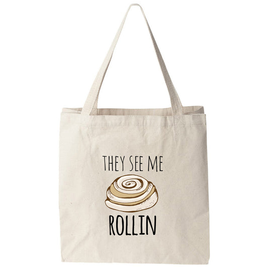 a tote bag that says they see me rollin