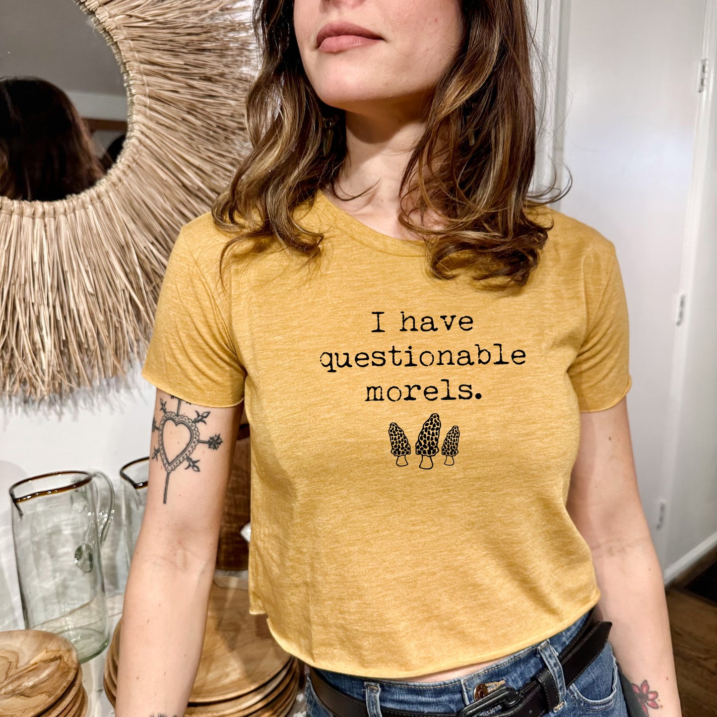 a woman standing in front of a mirror wearing a yellow shirt