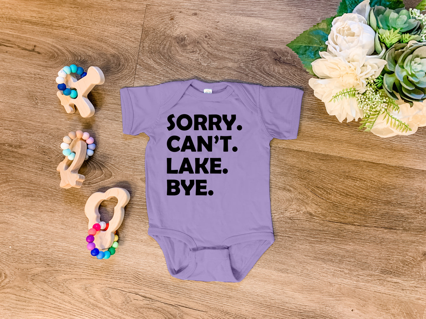 a baby bodysuit that says sorry, can't lake bye