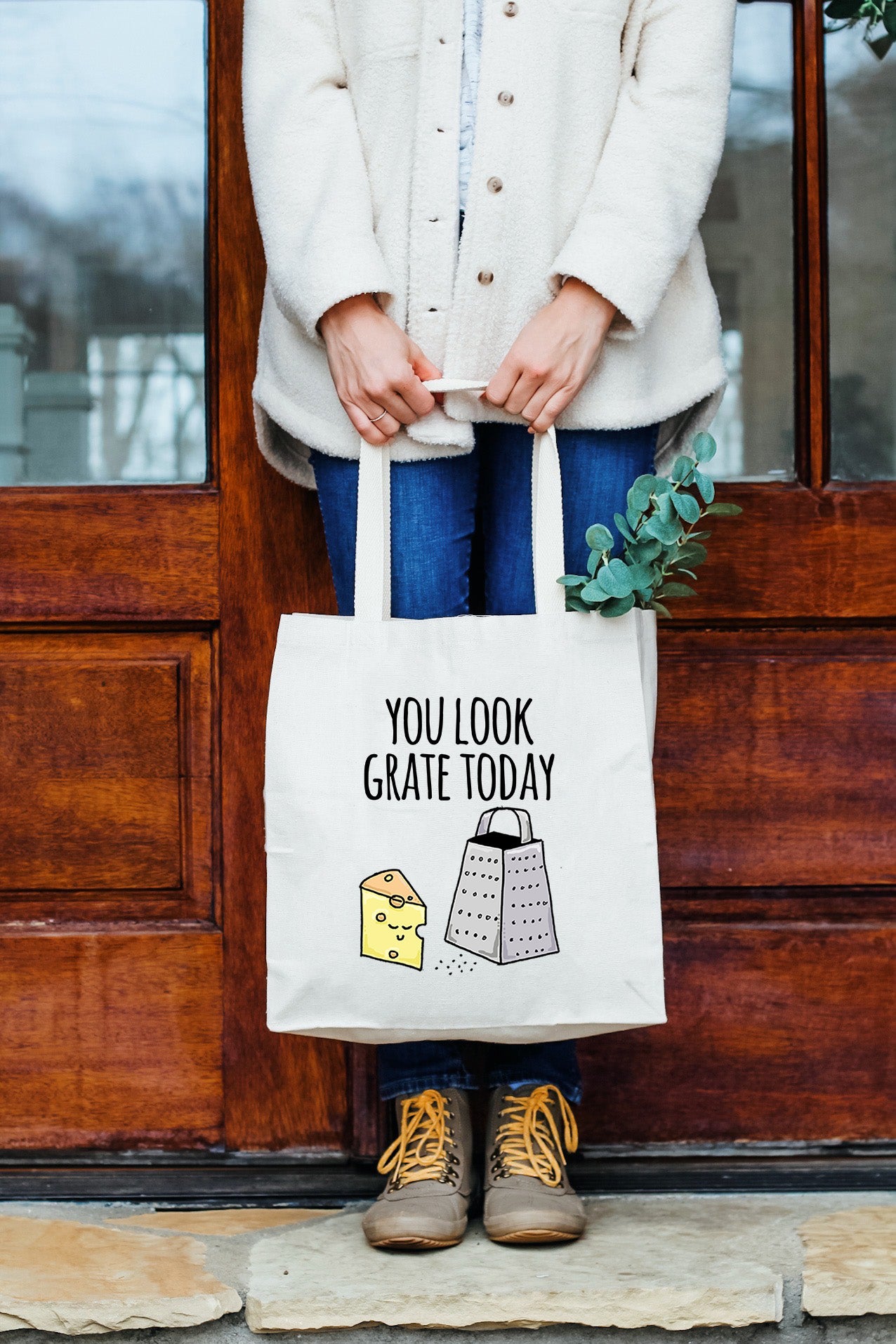 a woman holding a bag that says you look great today
