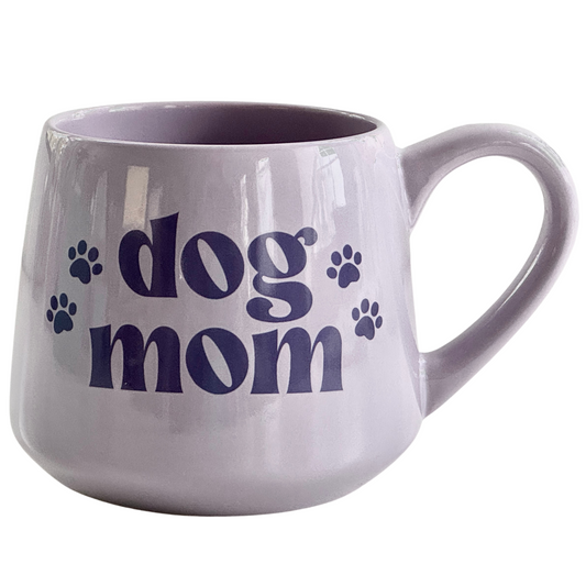 a dog mom coffee mug with paw prints on it