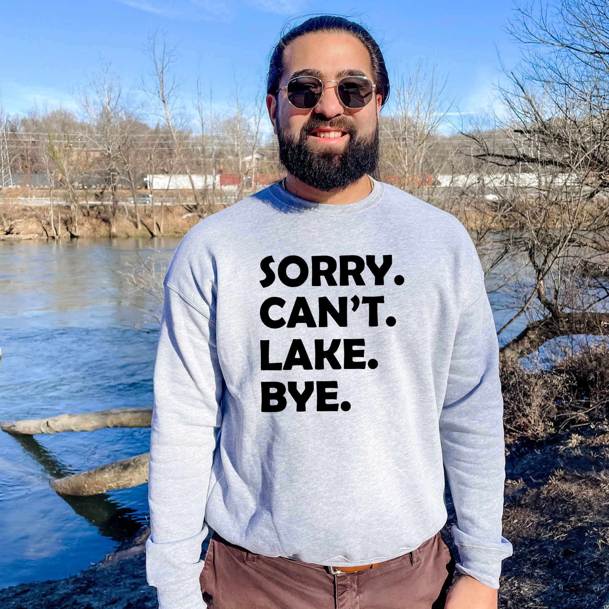 a man wearing a sweatshirt that says sorry, can't lake bye