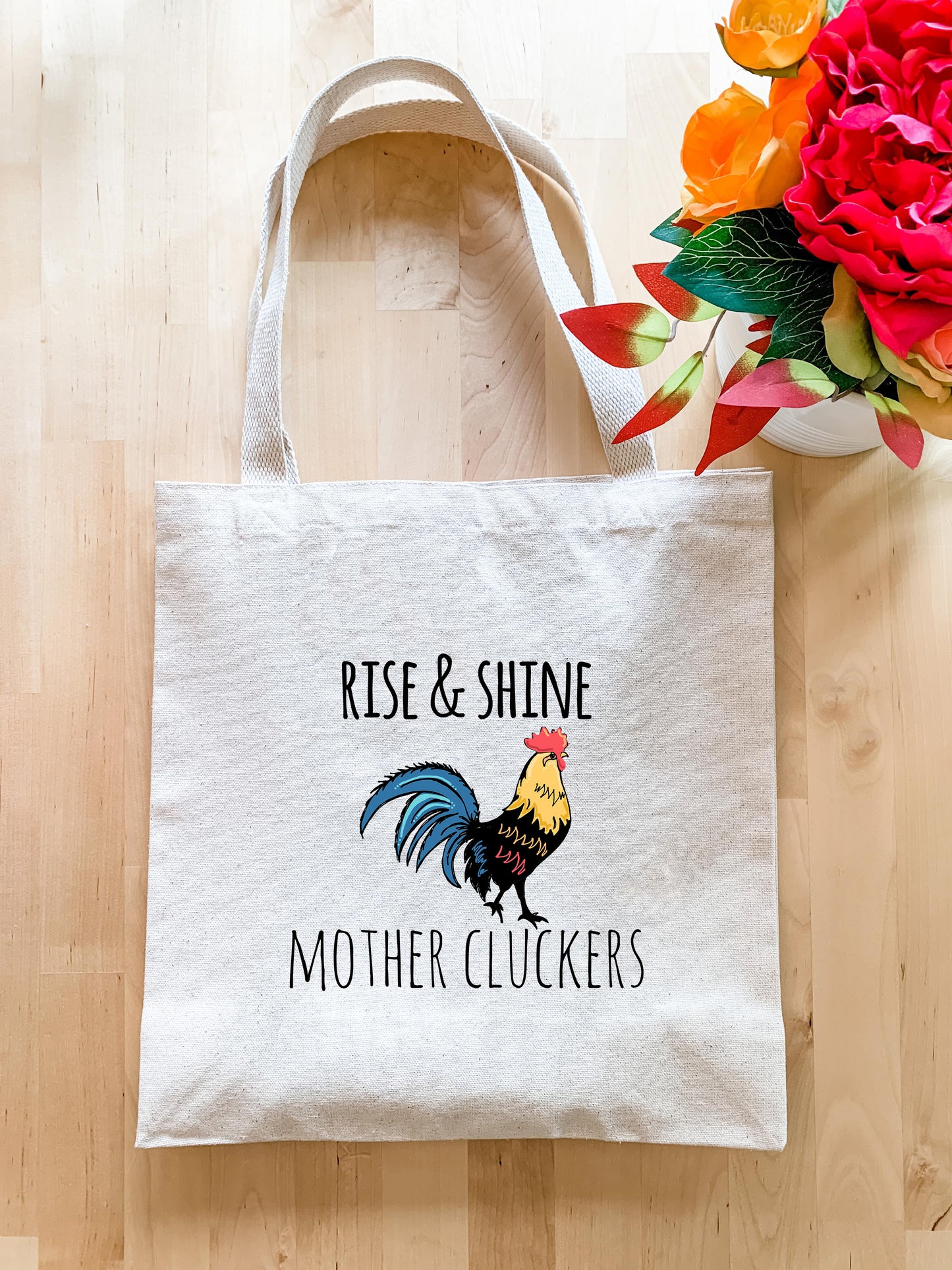 a white tote bag with a rooster on it