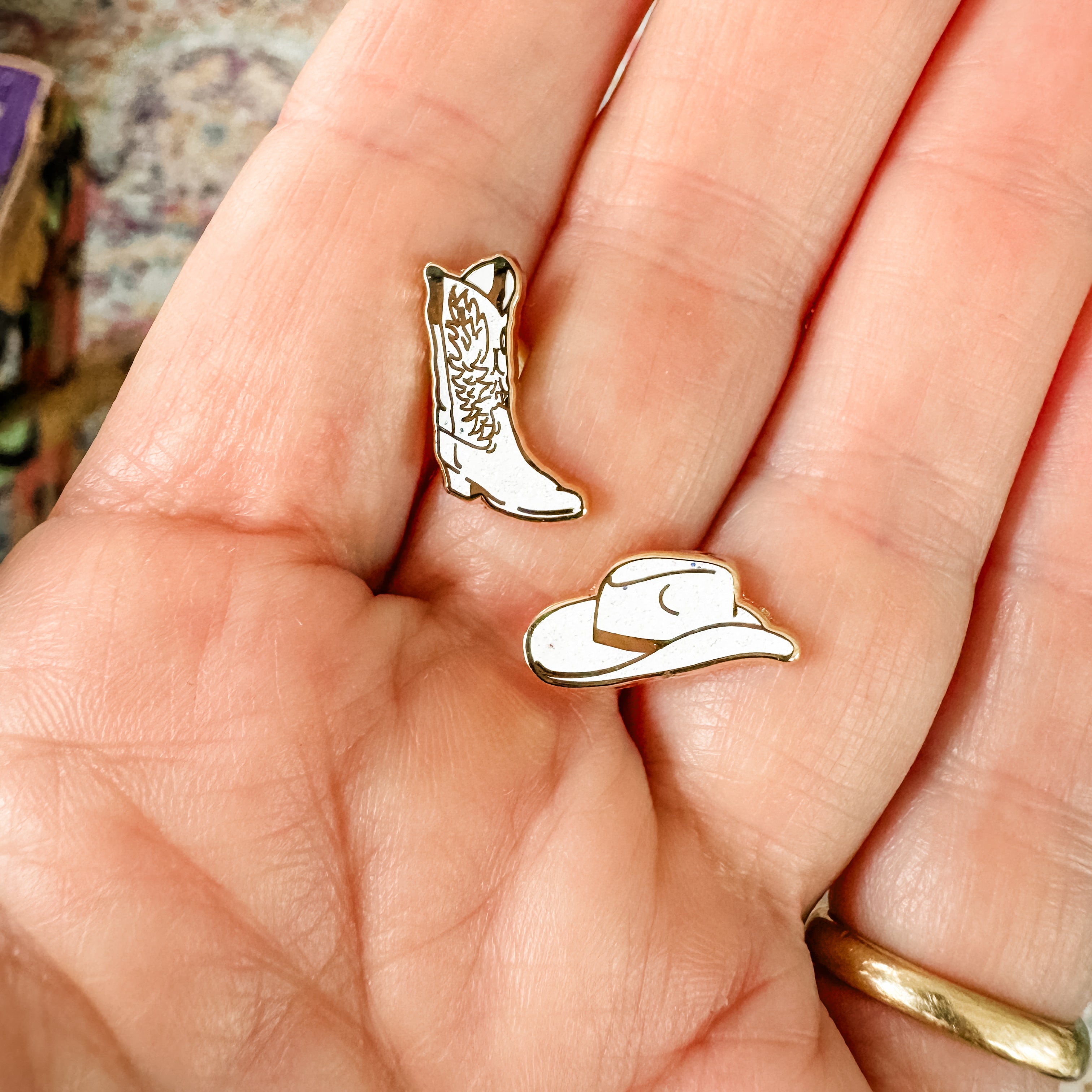 a person holding a pair of earrings in their hand