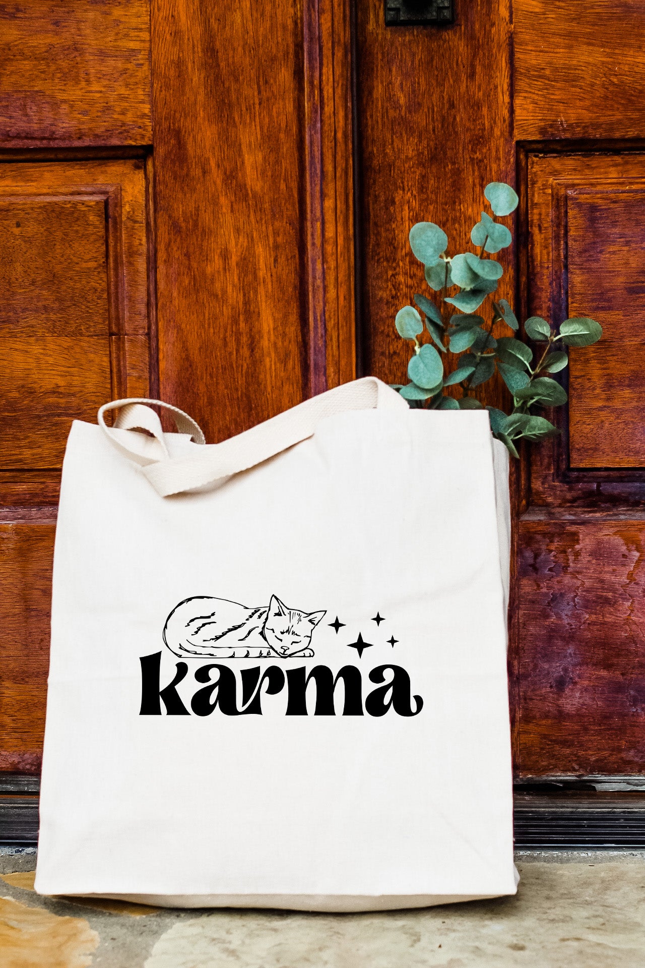 a white tote bag with the word karma printed on it