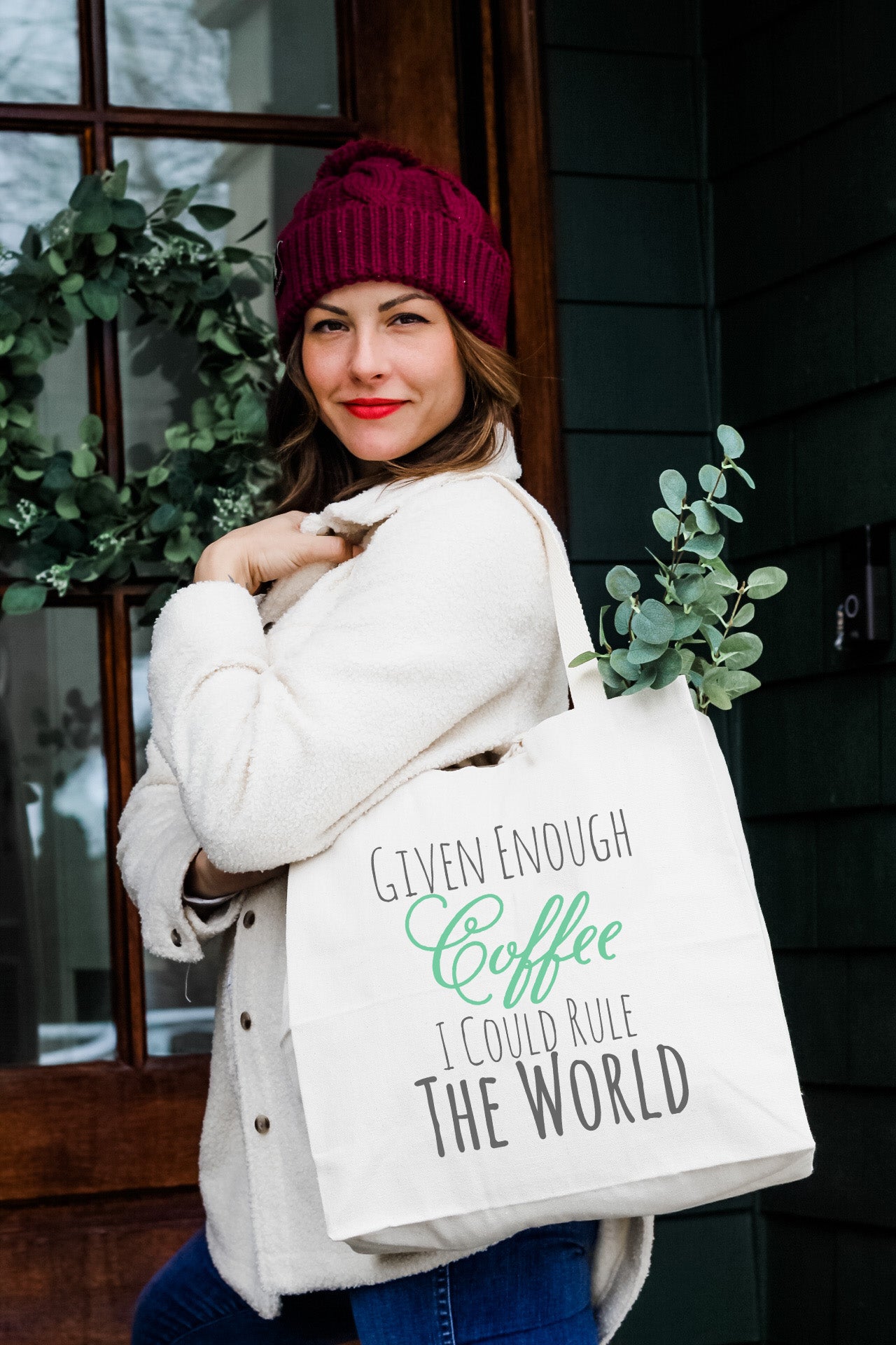 a woman carrying a bag that says given enough coffee could kill the world