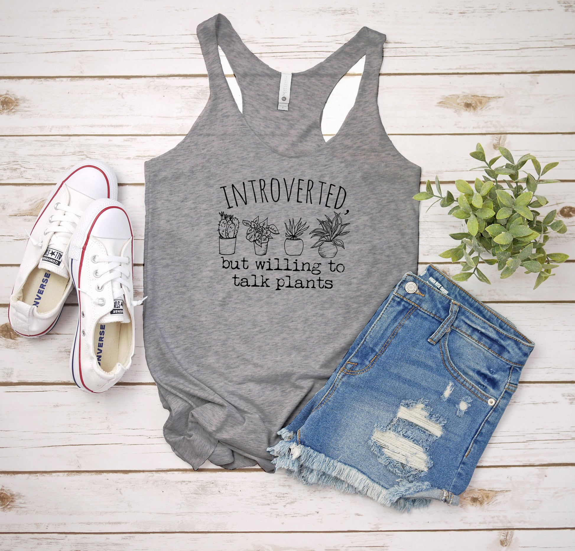 a women's tank top with a plant on it