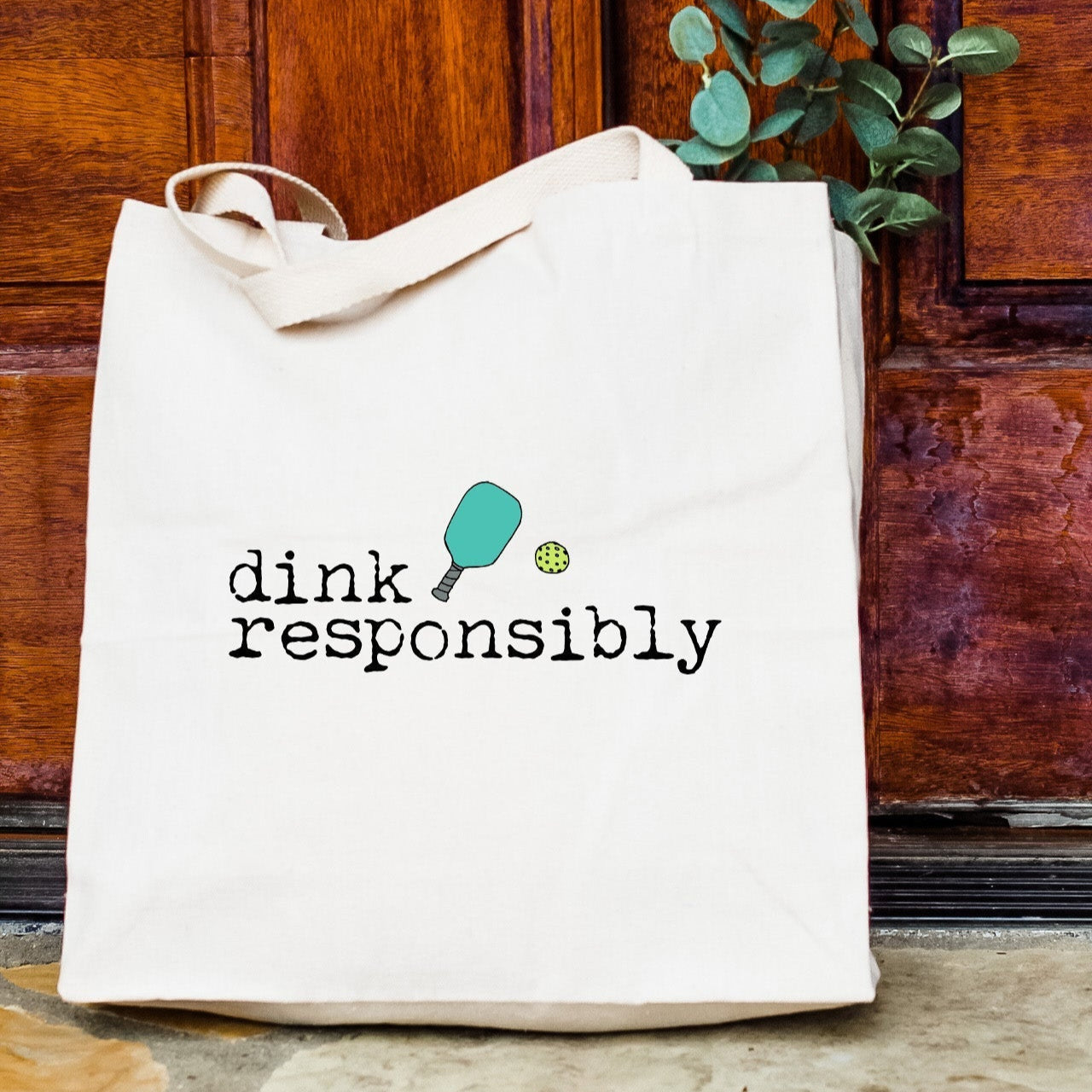 a white bag sitting on the ground next to a door