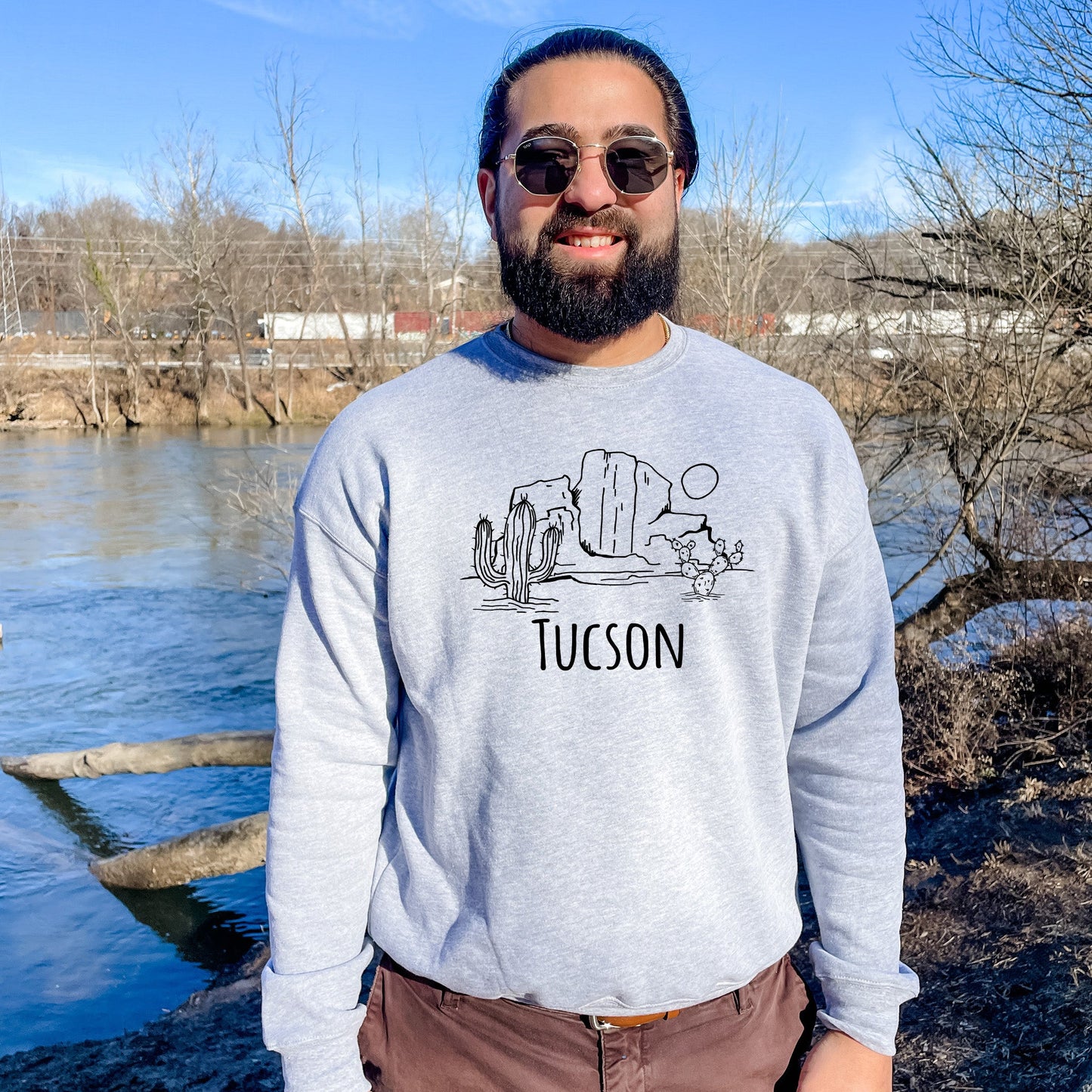 a man standing in front of a body of water