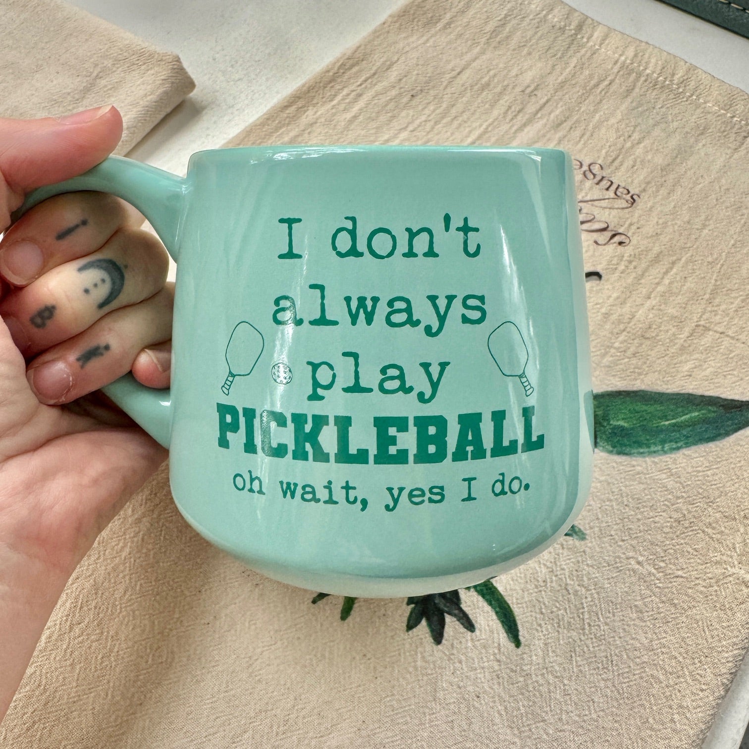 a person holding a cup with writing on it