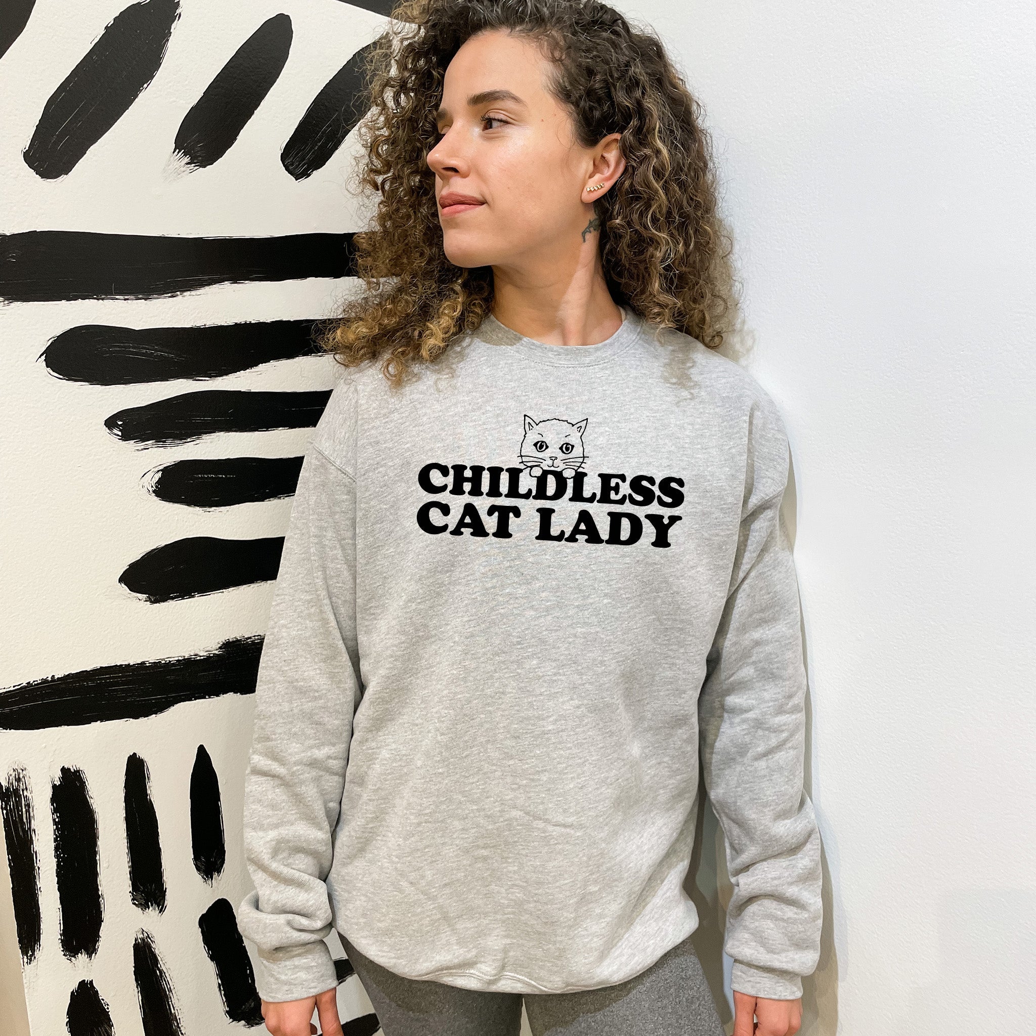 a woman standing in front of a painting