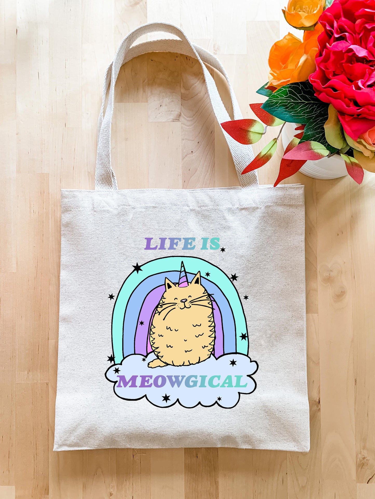 a white tote bag with a cat on it