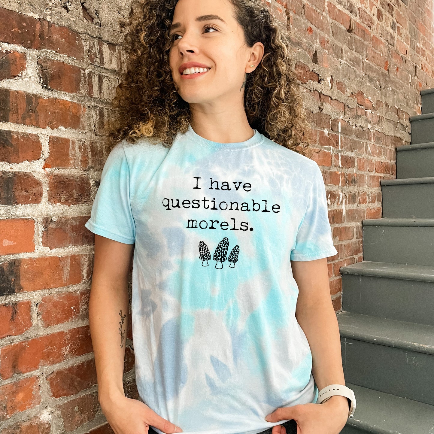 a woman standing in front of a brick wall