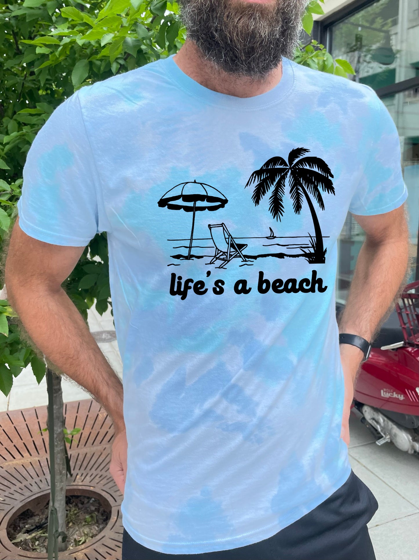 a man with a beard wearing a life's a beach t - shirt