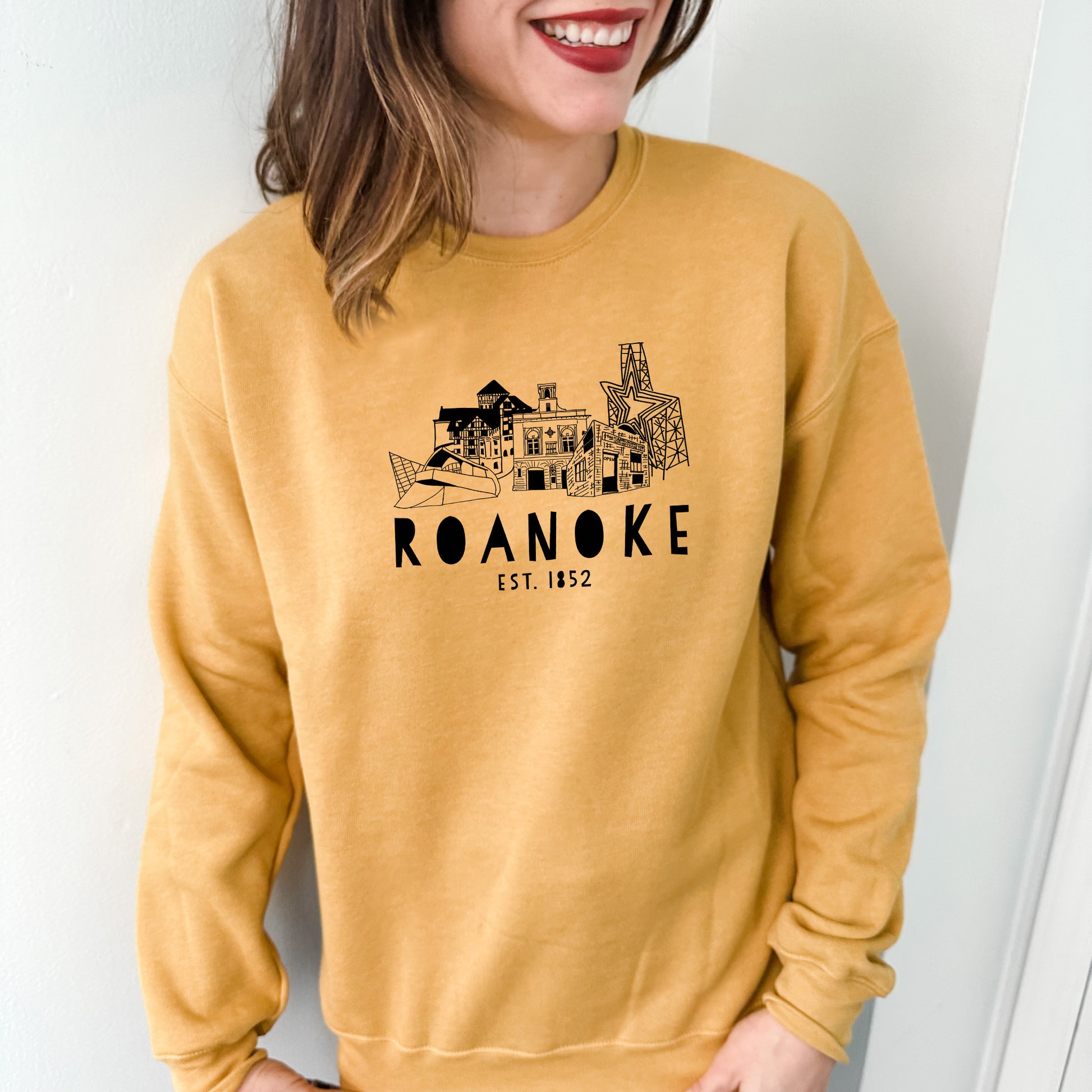 a woman wearing a sweatshirt with a picture of a building on it