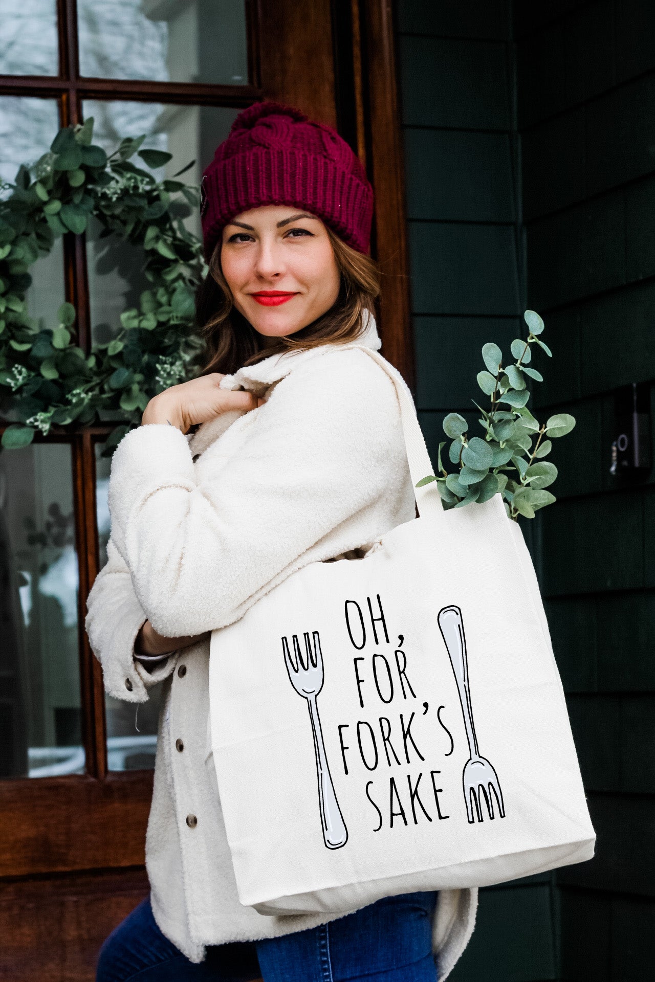 a woman carrying a bag that says, oh, for fork's sake