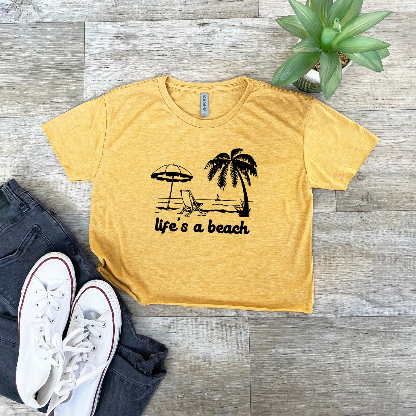 a t - shirt that says life's a beach next to a pair of