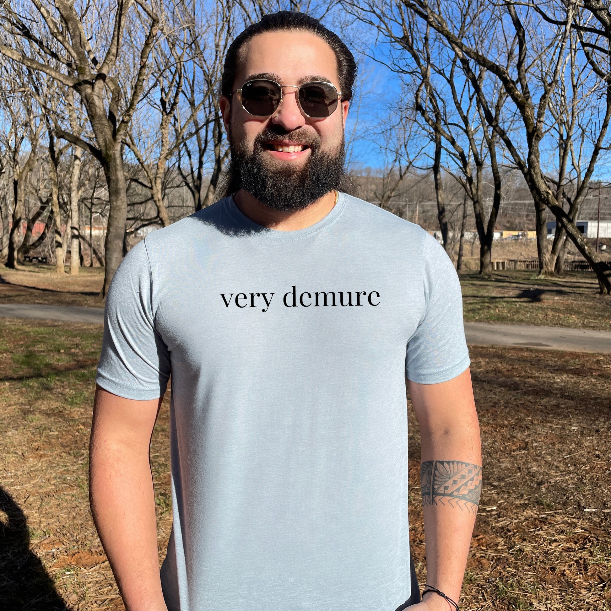 a man with a beard wearing a very demure t - shirt