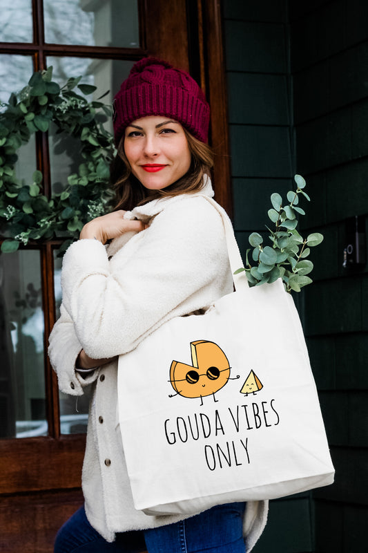 a woman carrying a bag that says godavibes only