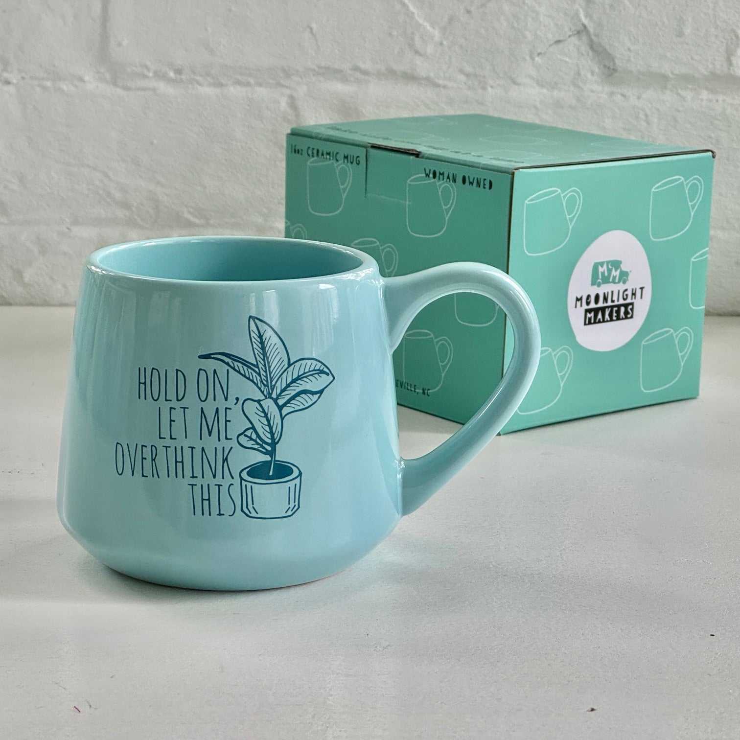 a blue coffee mug sitting next to a box of coffee