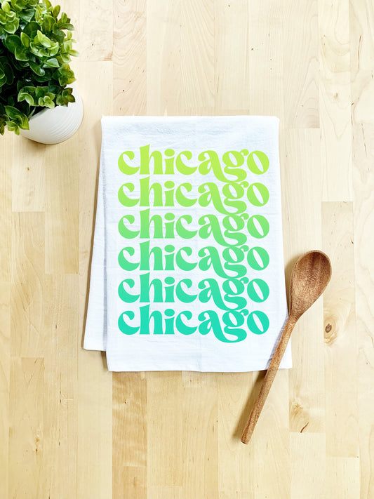 a white towel with chicago written on it next to a wooden spoon