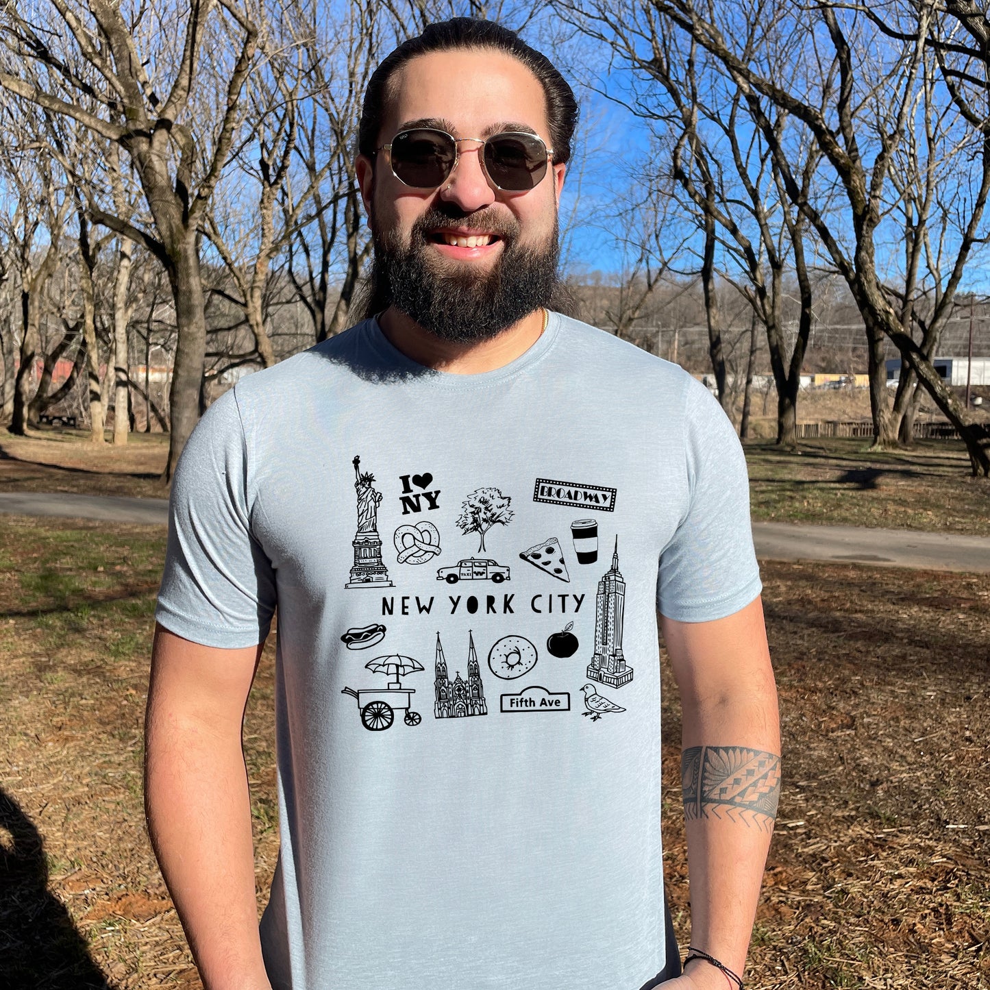 a man with a beard wearing a new york city t - shirt