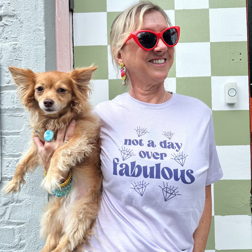 a woman in a white shirt holding a brown dog