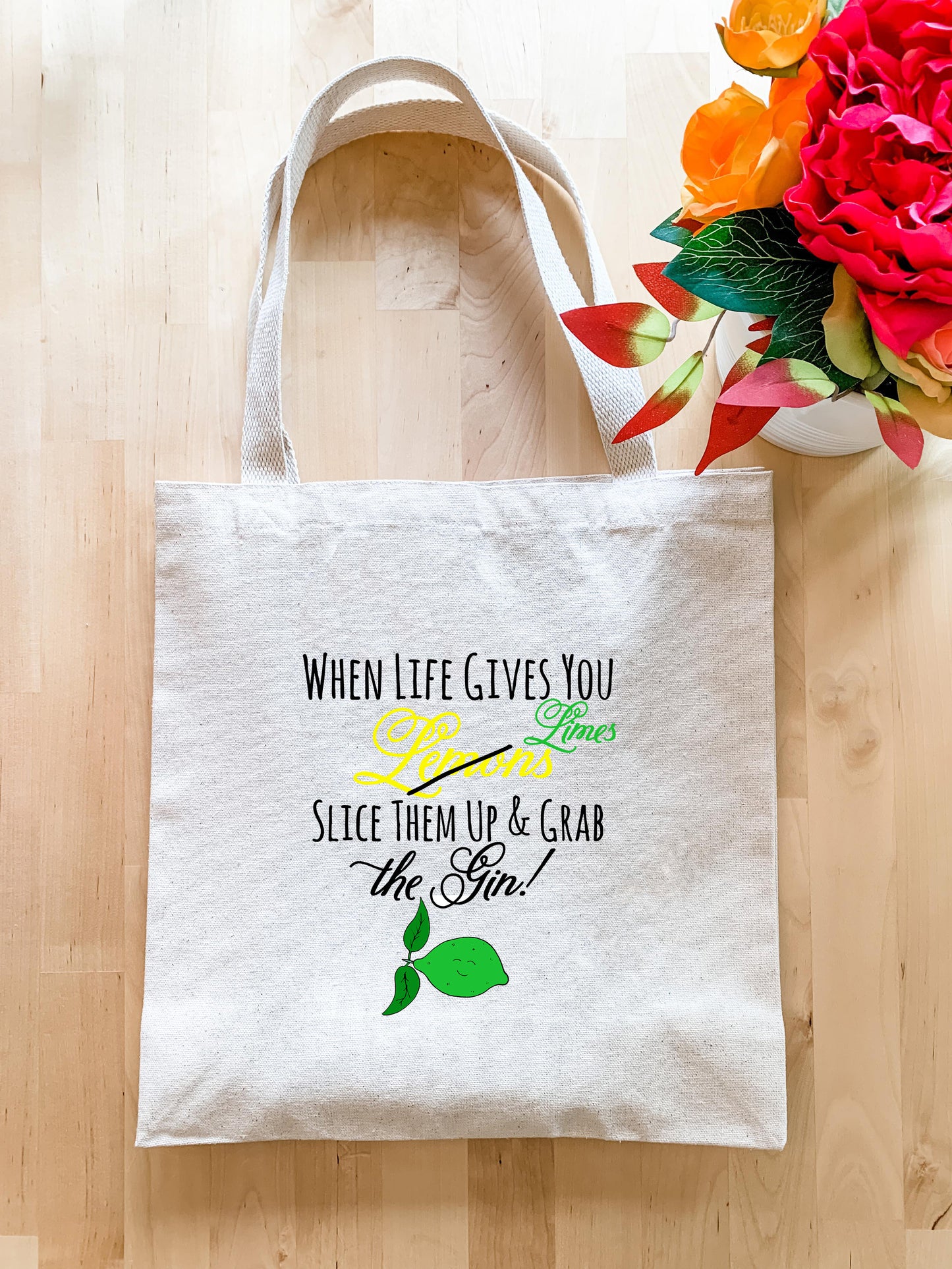 a white tote bag sitting on top of a wooden floor