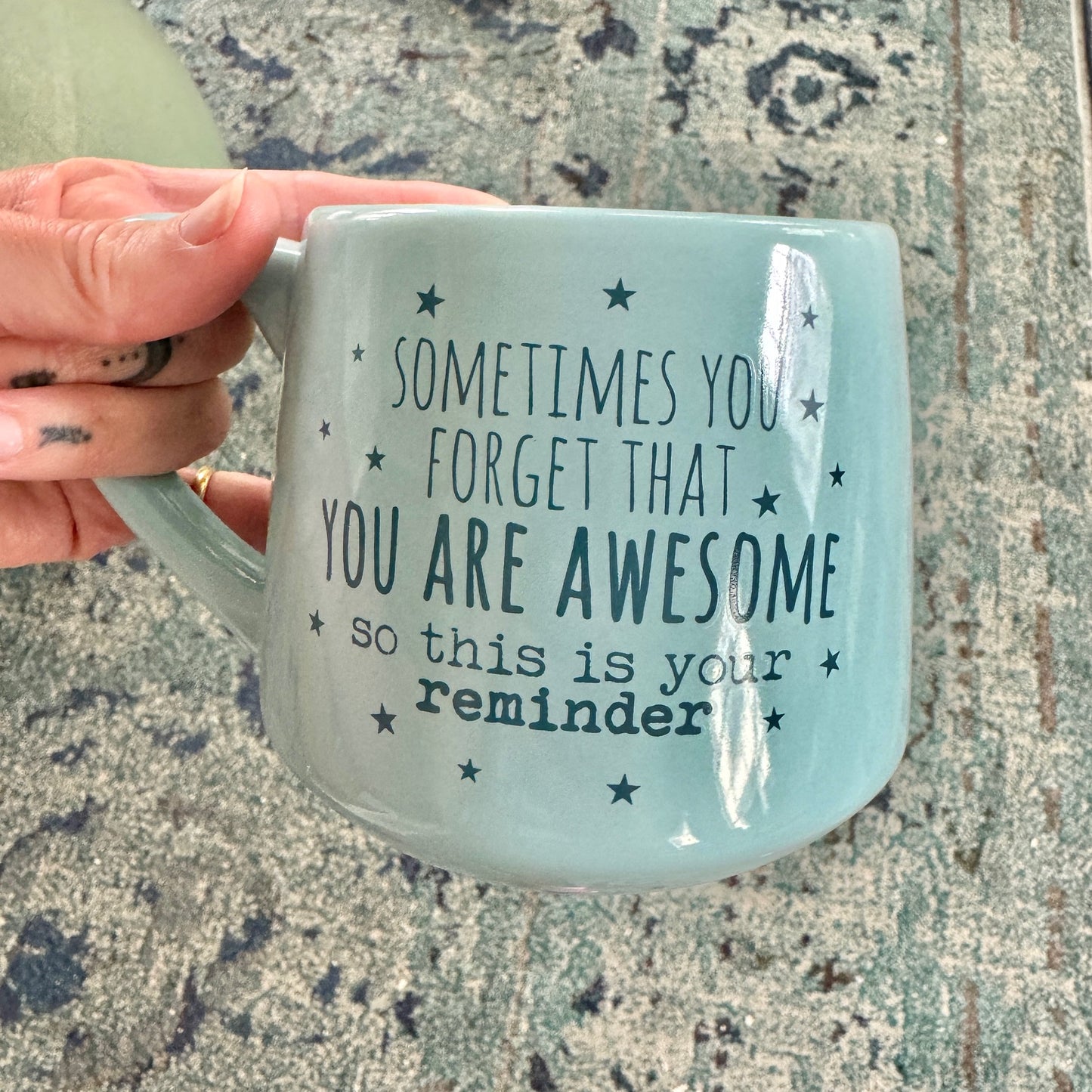 someone holding a coffee mug that says sometimes you forget that you are awesome