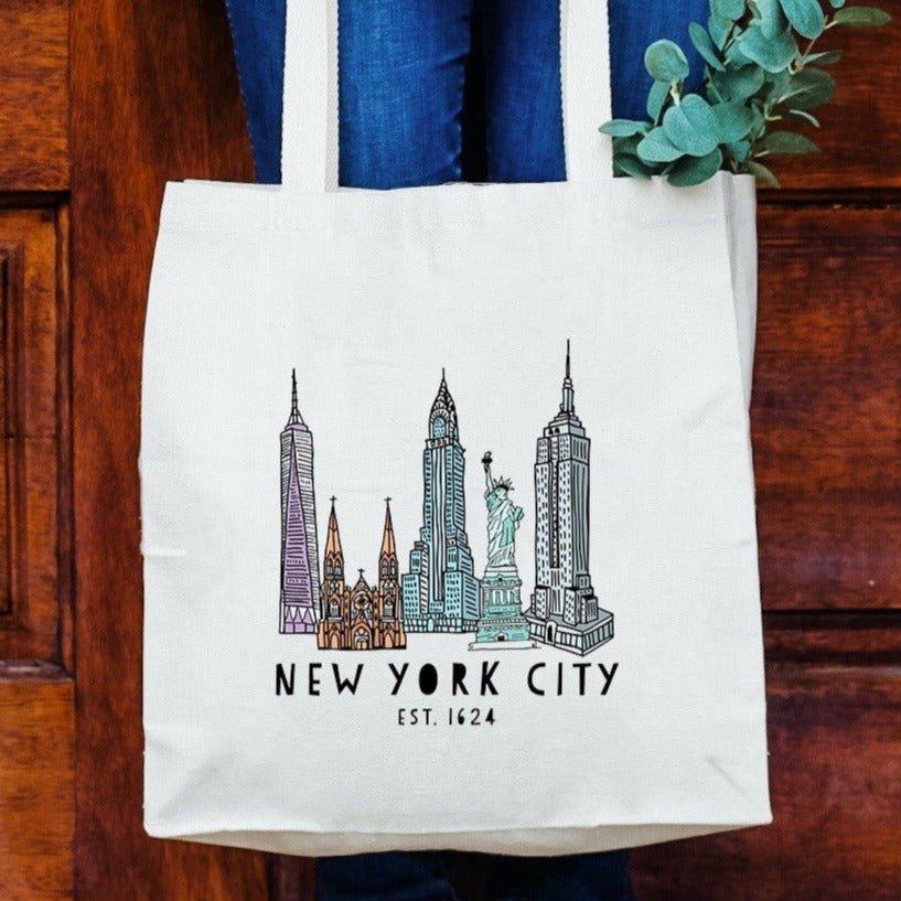 a woman holding a new york city tote bag
