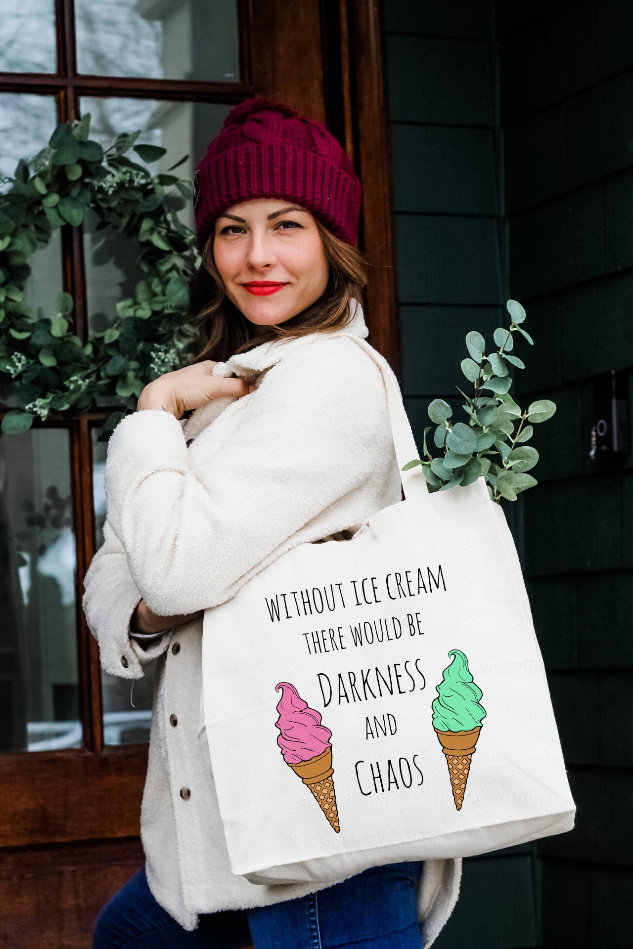 a woman carrying a bag with ice cream on it