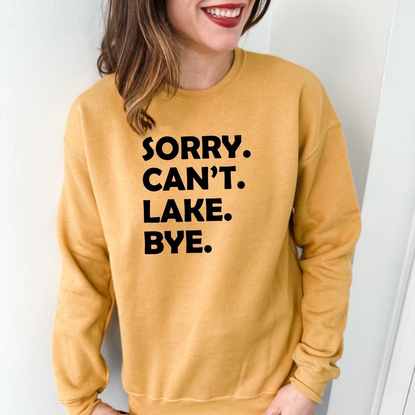 a woman wearing a sweatshirt that says sorry can't lake bye