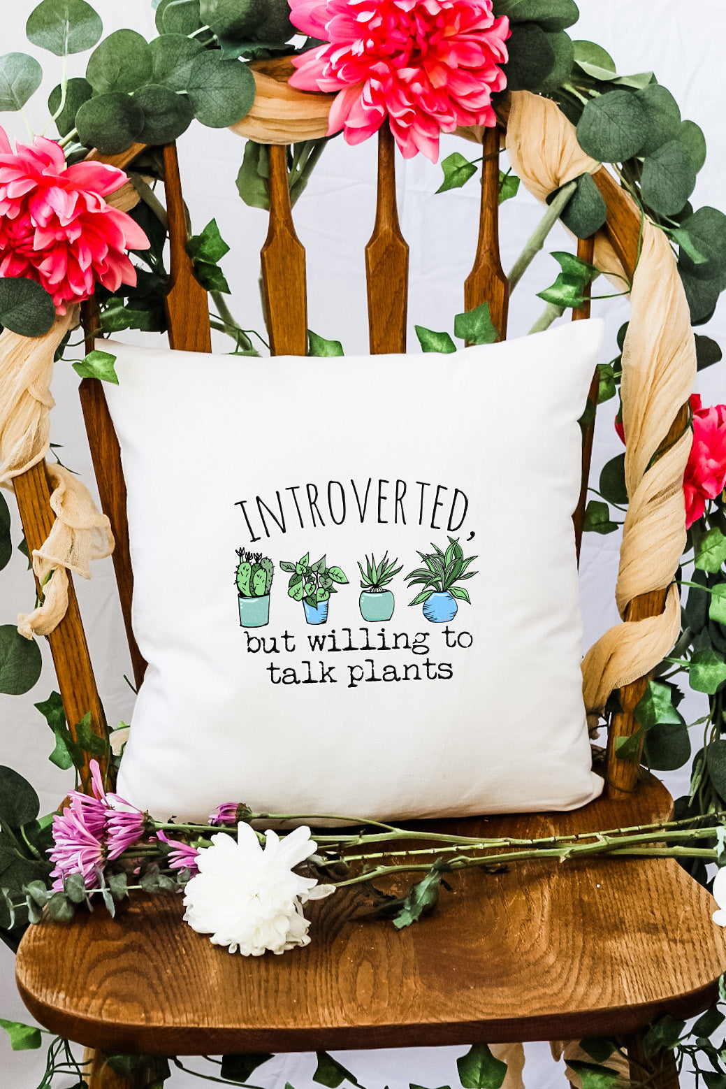 a pillow with a plant on it sitting on a chair