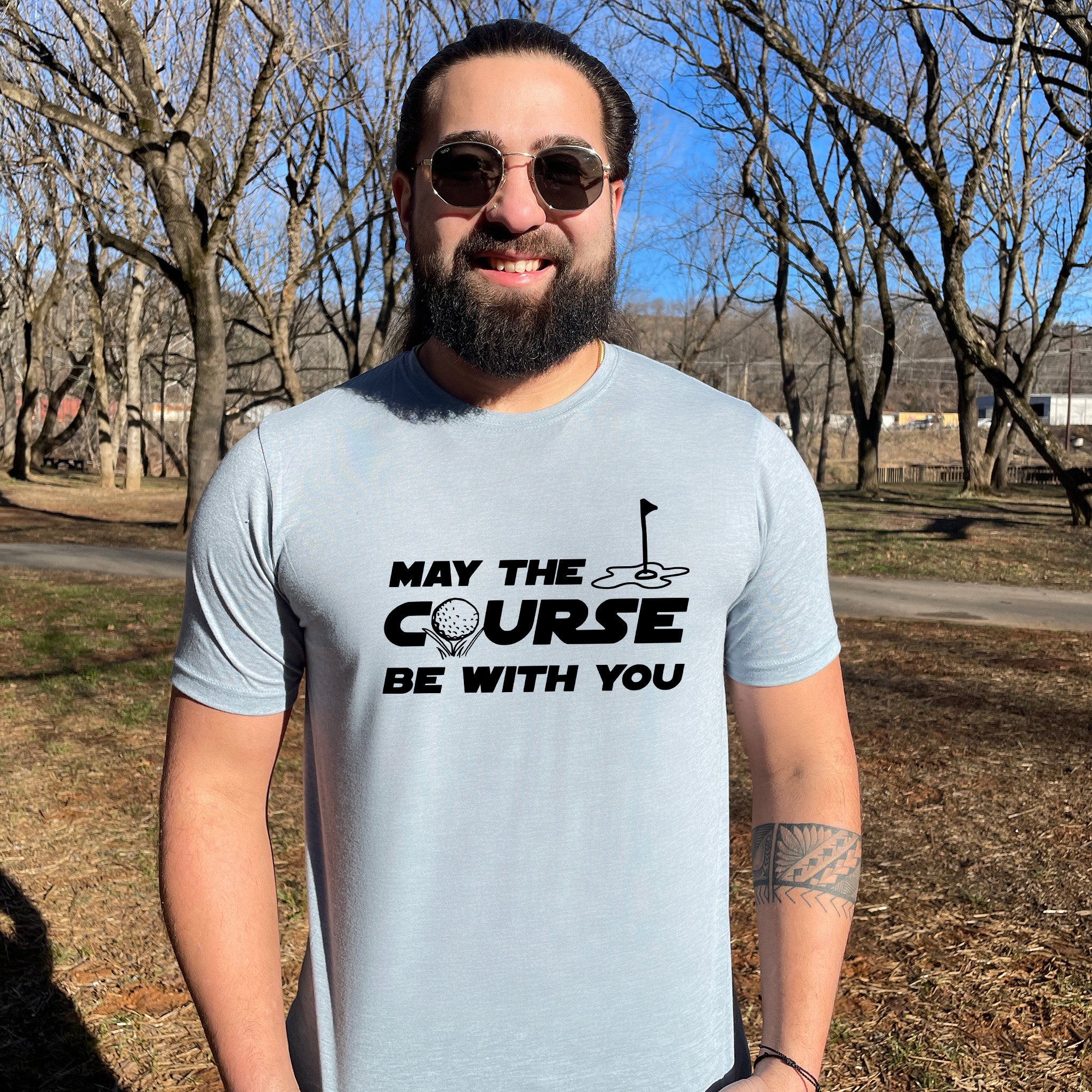 a man wearing a t - shirt that says may the course be with you