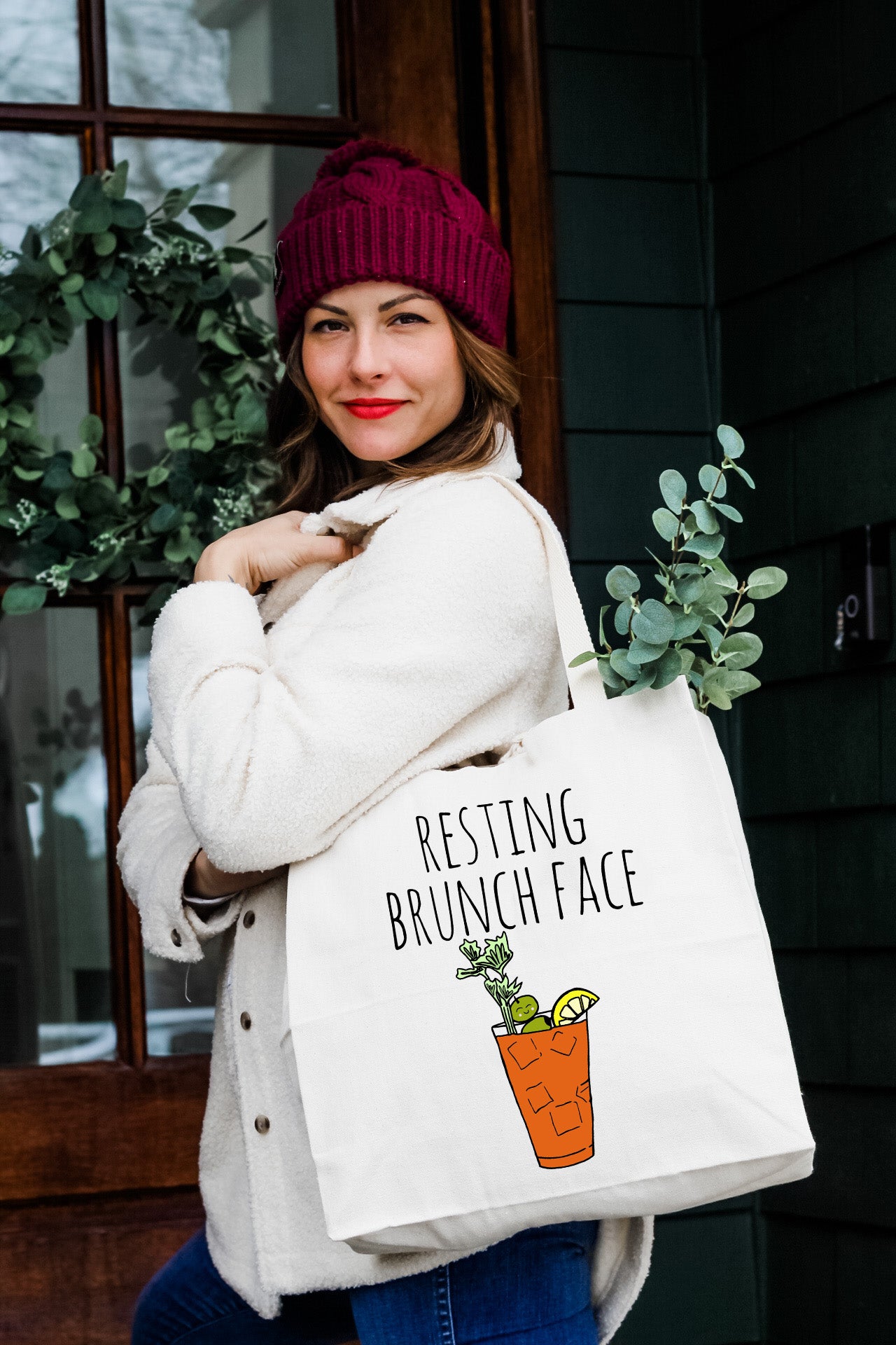 a woman holding a white bag with a carrot in it