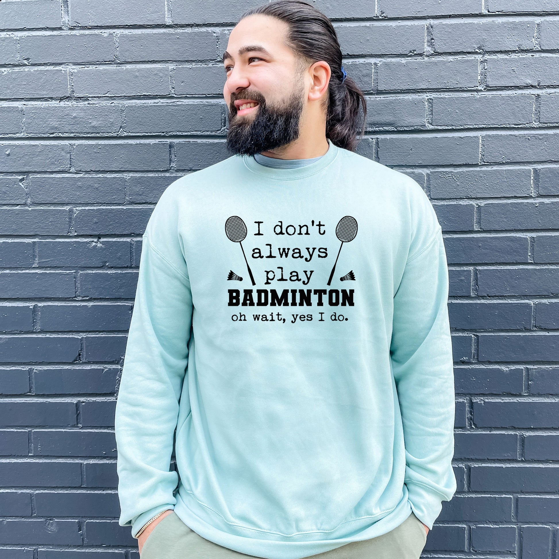 a man with a beard wearing a sweatshirt that says badminton