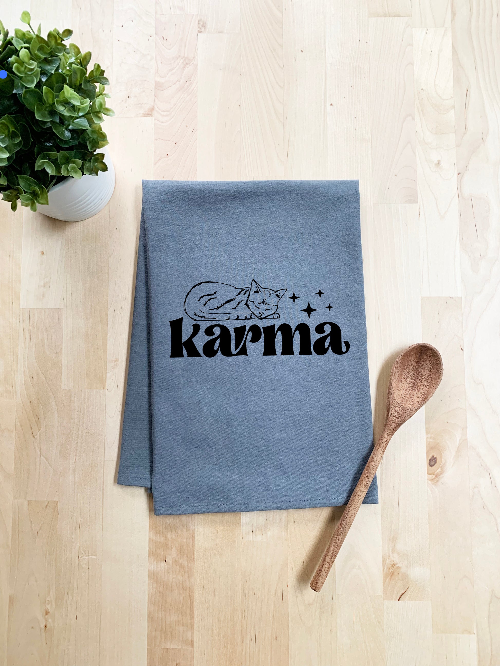 a tea towel with the word karnna on it next to a wooden spoon