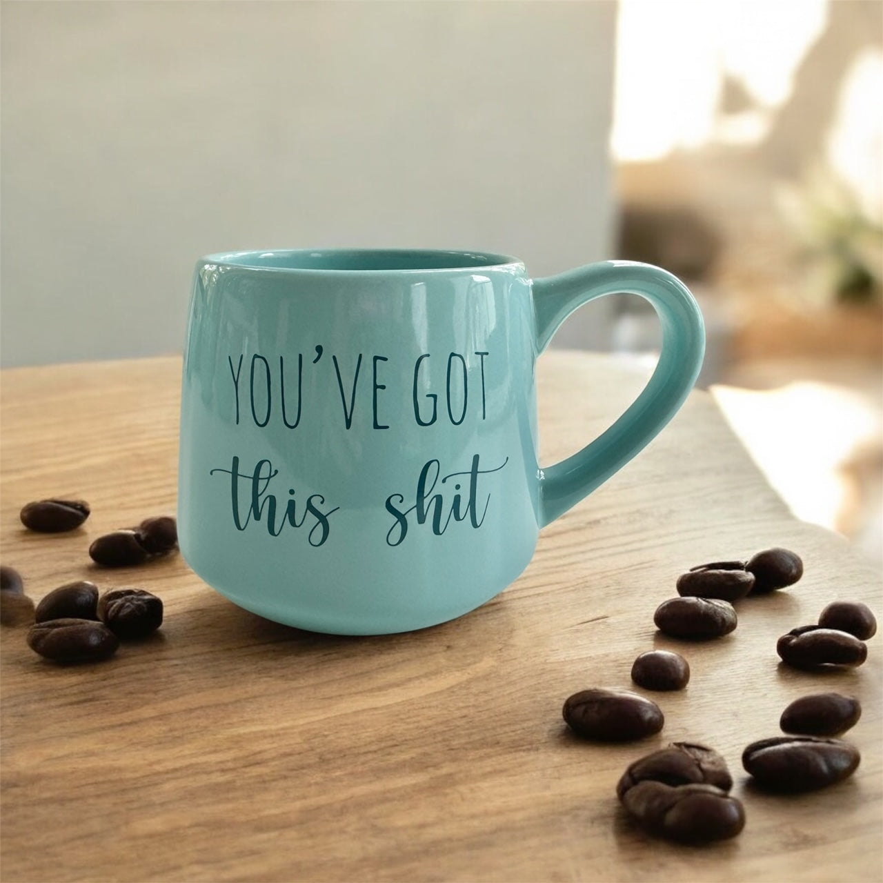 a blue coffee mug sitting on top of a wooden table